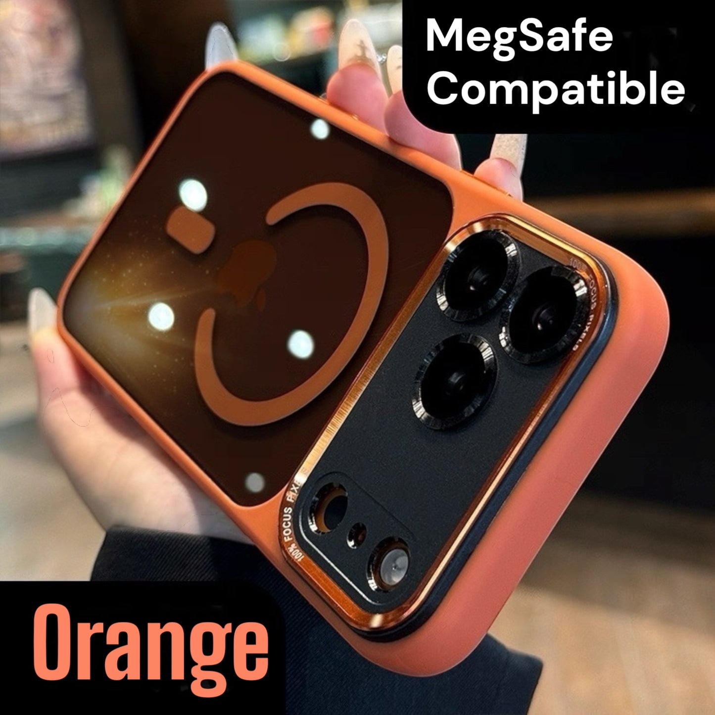 Orange iphone 17 pro max case with a smiley face design held by a hand, labeled 'MegSafe Compatible'.