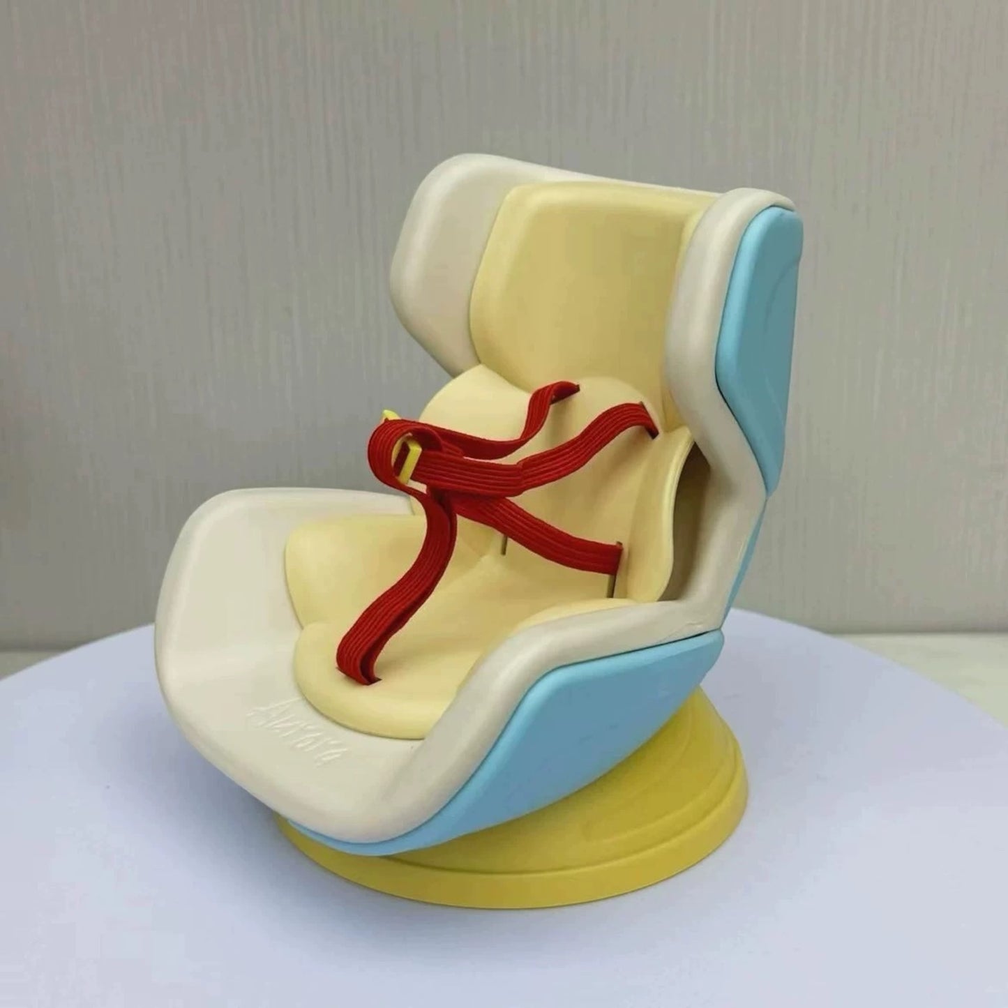 Child safety seat with a red strap on a white background