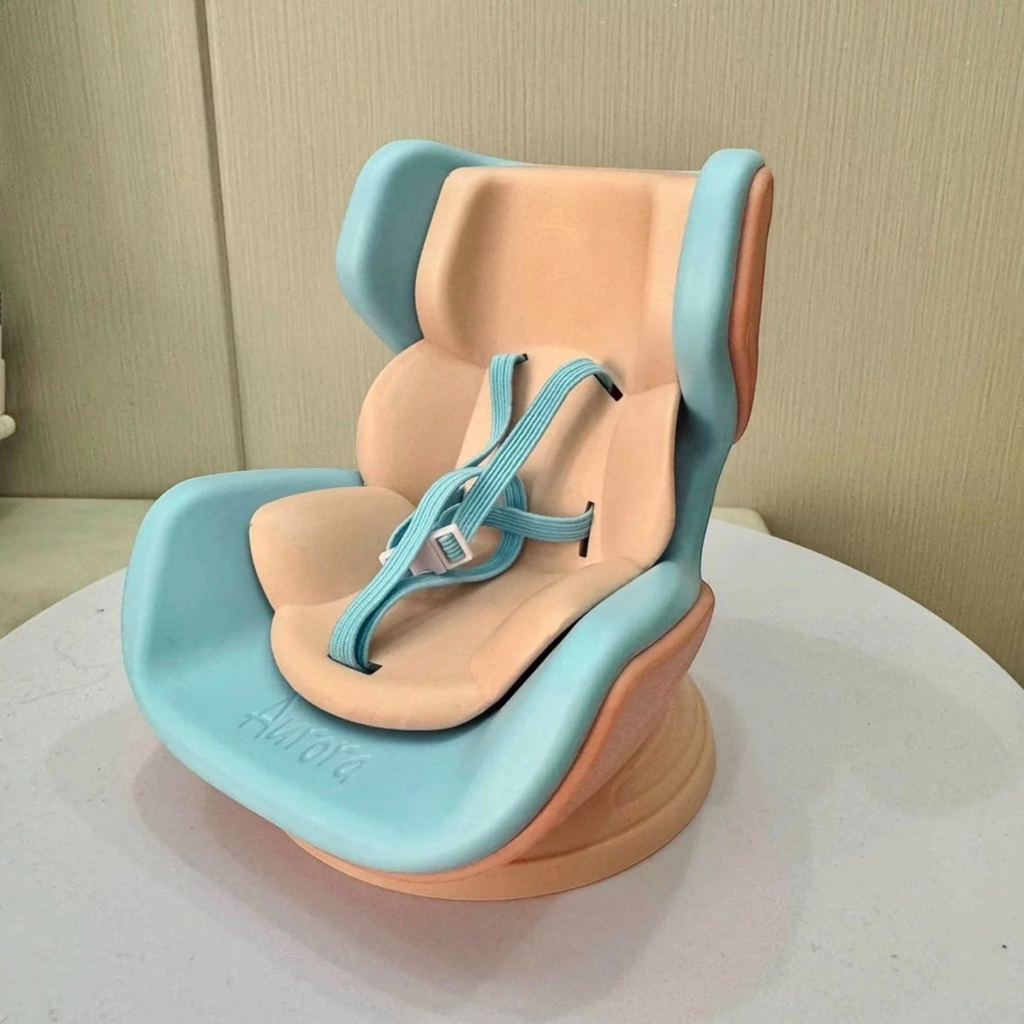 Baby seat with blue and beige colors on a neutral background