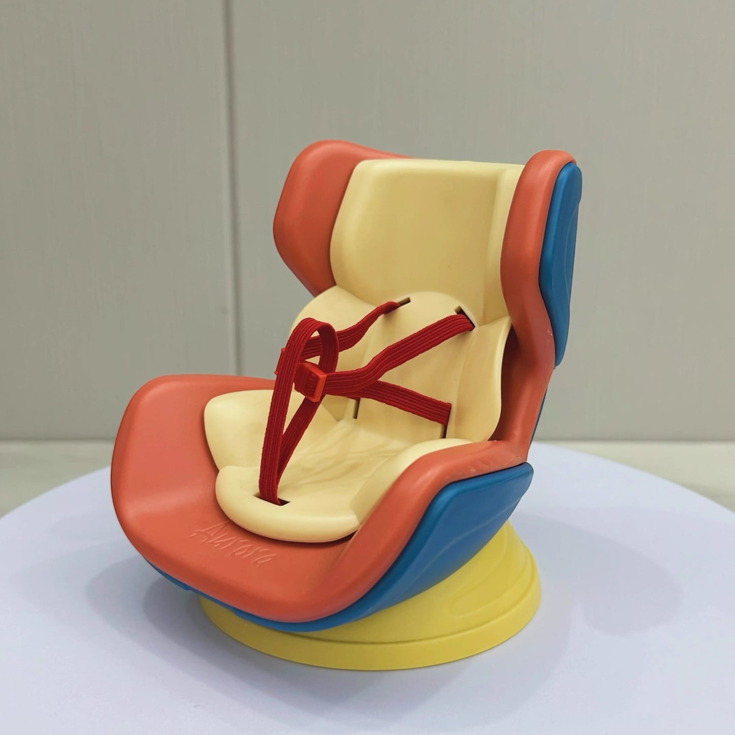 Colorful baby seat with red, yellow, and blue design on a neutral background