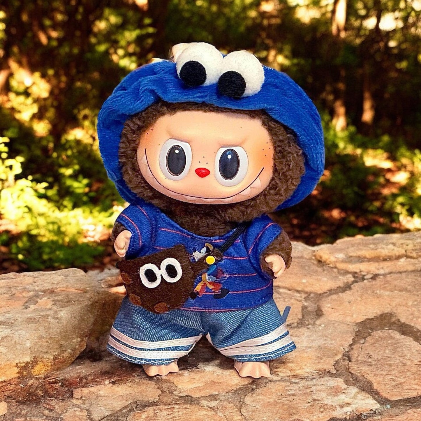 A Blue Cookie Monster Costume outfits on Labubu 17cm Doll with forrest background