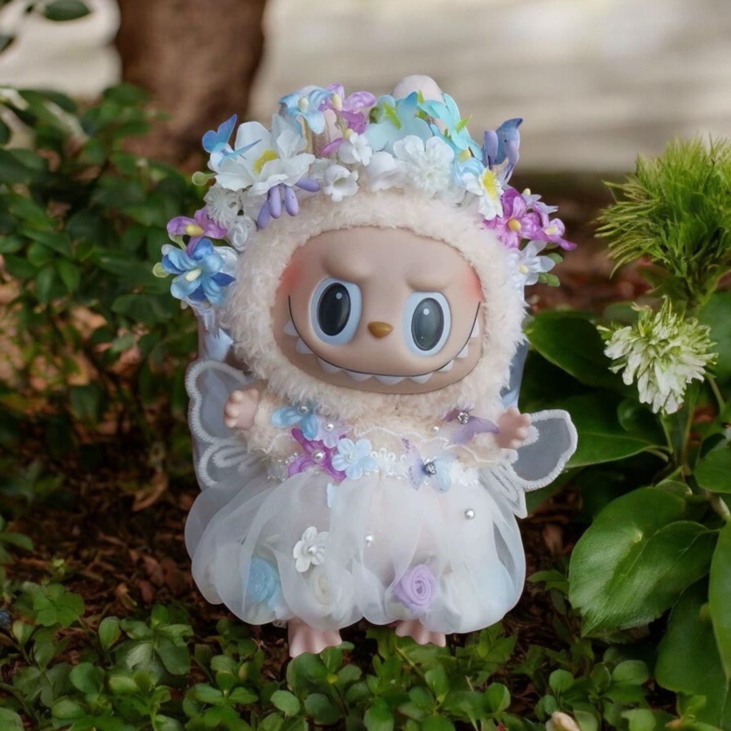 Toy figure with floral headband and dress on a natural background
