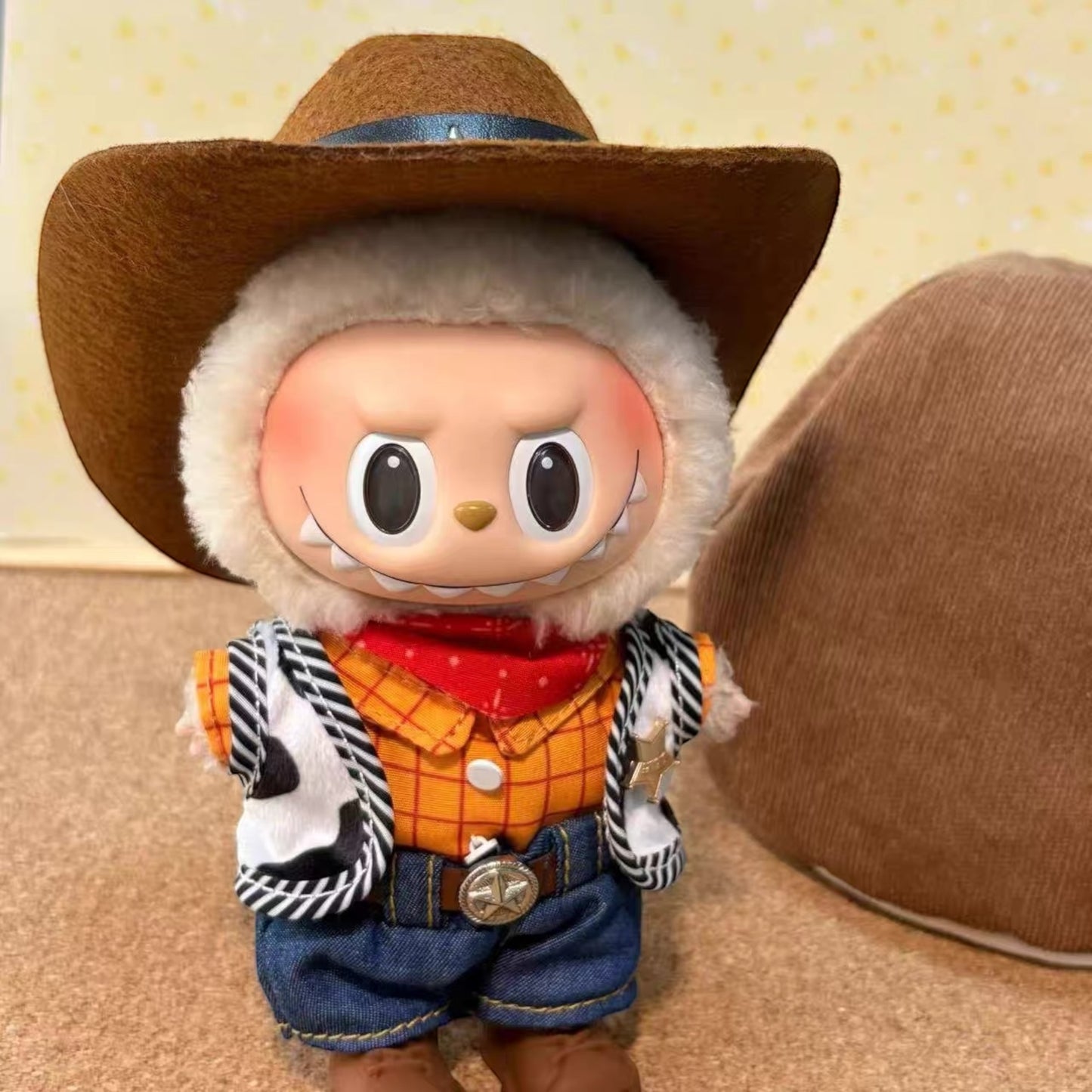 Toy figure of a character in Woody cowboy attire with a large brown hat.