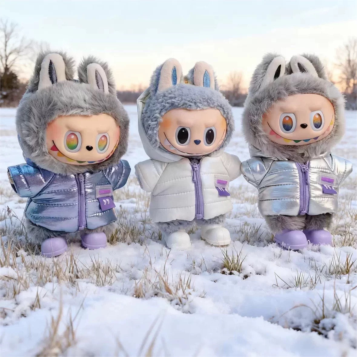 Labubu wearing in winter outfits standing in a snowy landscape.
