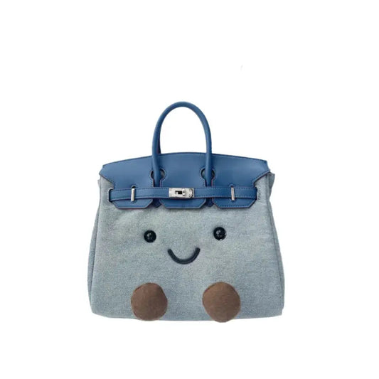Light blue denim-style plush handbag with smiley face and 3D feet.