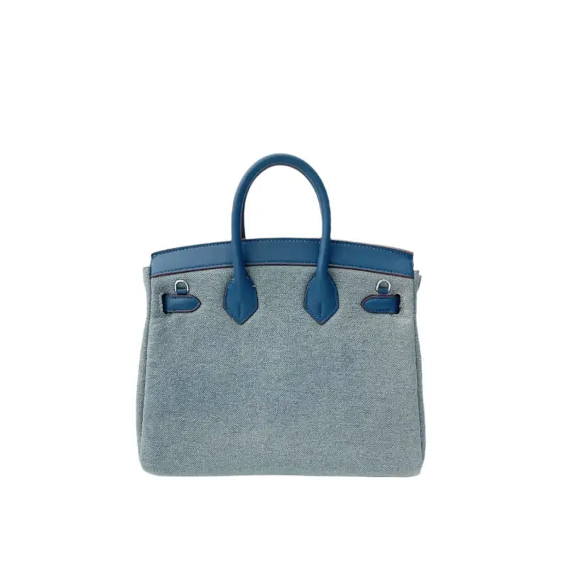 Cute denim satchel bag styled on model – kawaii plush fashion accessory with silver hardware
