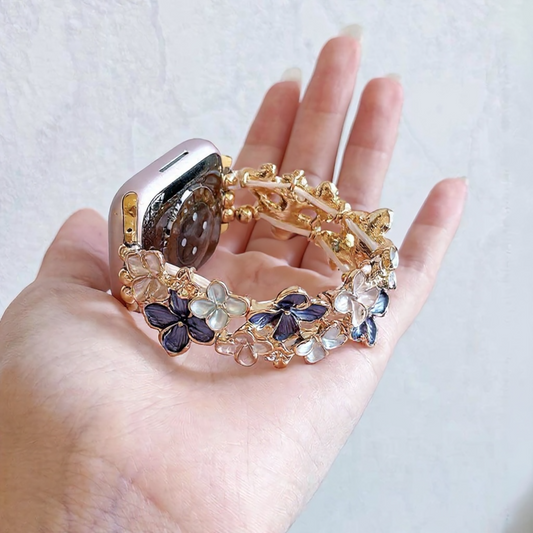 gold-apple-watch-bracelet-purple-enamel-flowers-rhinestones-holding-in-hand