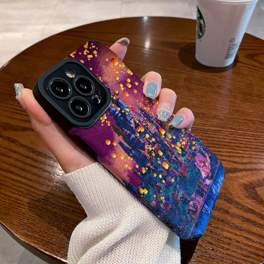 Hand holding a iPhone case with a colorful castle design on a wooden table with a Starbucks cup in the background.