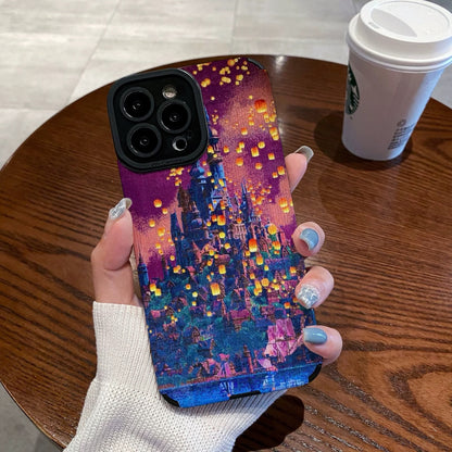 Hand holding a iPhone case with a colorful castle design on a wooden table with a Starbucks cup in the background.