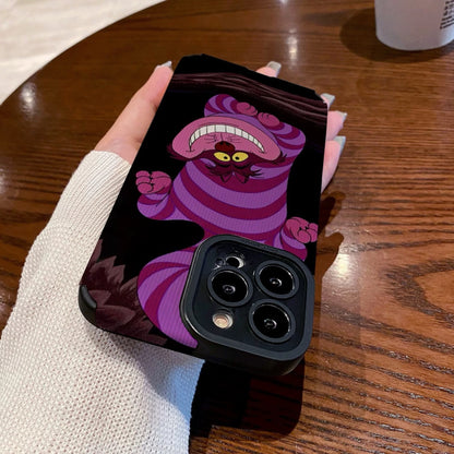 Hand holding a iPhone case with a Cheshire Cat of Alice in Wonderland on a wooden table with a Starbucks cup.