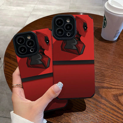 Red iphone case with Dead Pool design held by a hand on a wooden table with a Starbucks cup.