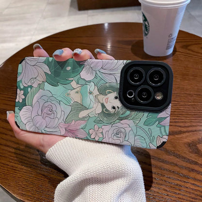 Hand holding a iPhone case with a Jasmine with floral design and character, Starbucks cup in the background.