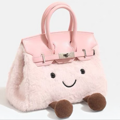 Pink kawaii plush handbag with luxury satchel silhouette — angled front view showing leather-look handles and silver hardware