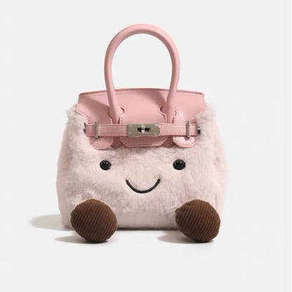 Cute character kawaii bag in blush pink plush — close-up of embroidered smiley face and turnlock clasp