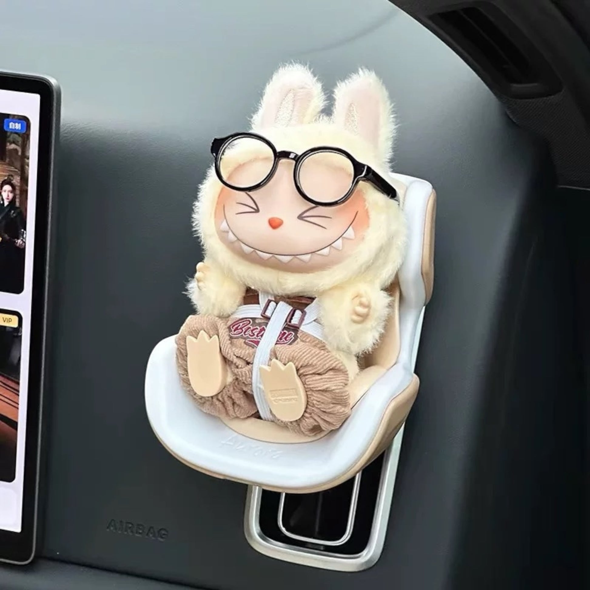 Plush toy Labubu Doll with glasses attached to a car's air vent