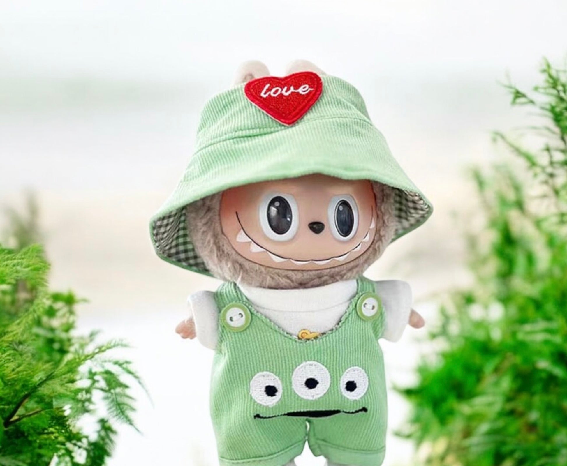 Toy figure with a green hat and overalls standing outdoors