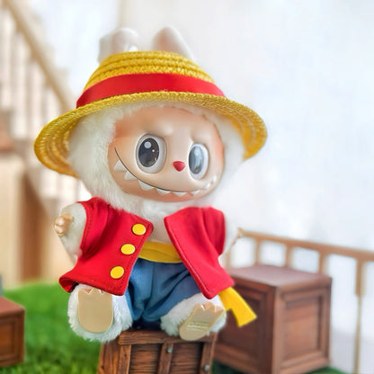 Two plush toys resembling characters One Piece Luffy and Chopper from a popular anime series on grass with a blurred background.