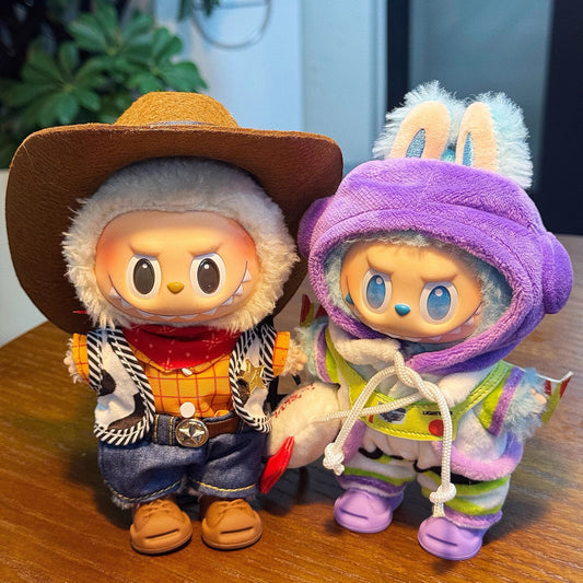 Two animated characters toy story - woody and buzz lightyear, one in a cowboy outfit and the other in a purple snowsuit with bunny ears, on a wooden surface.