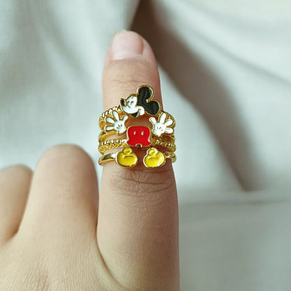 Hand wearing a Gold cartoon-themed Vintage Mickey Mouse ring with a white background